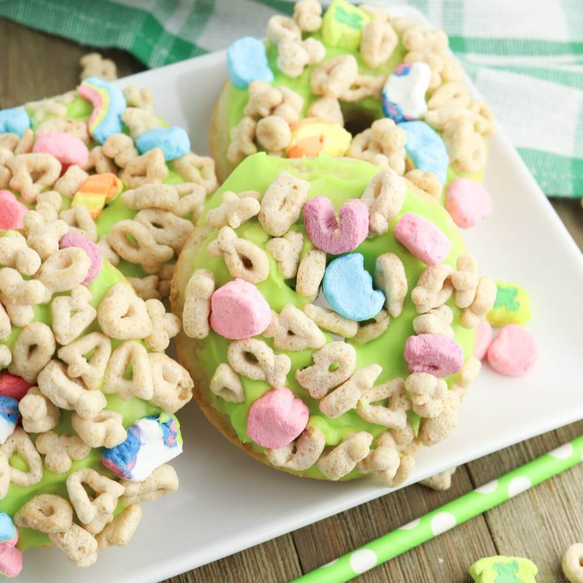 Lucky Charms donuts sitting on a white plate.