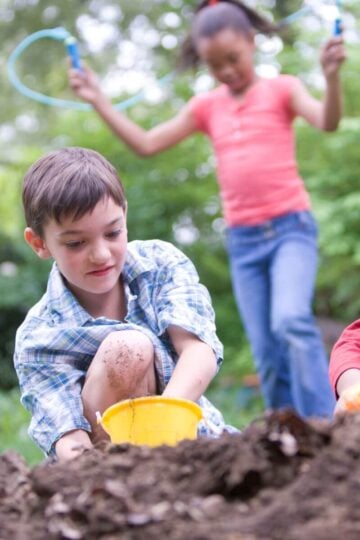 Kids outside playing in the dirt. Screen-free summer activities.