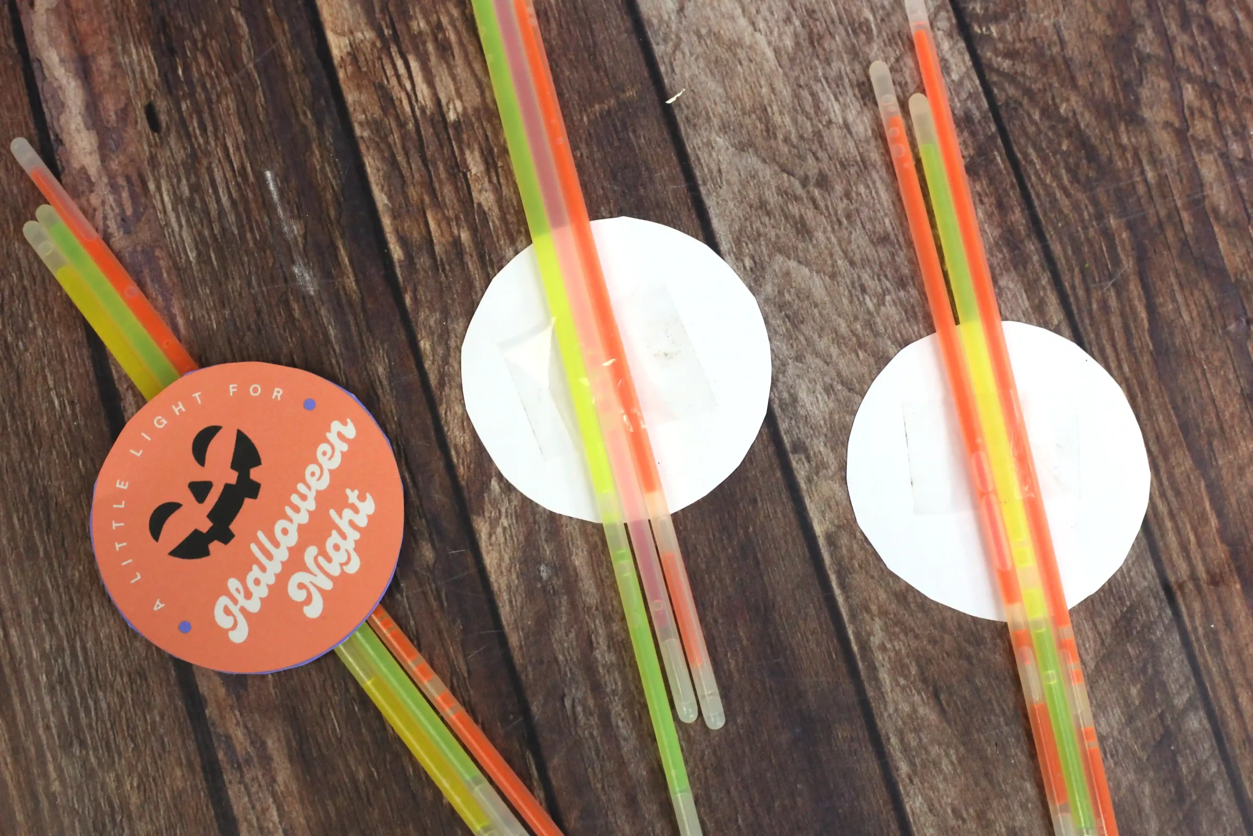 glow sticks taped to the back of printable halloween tags