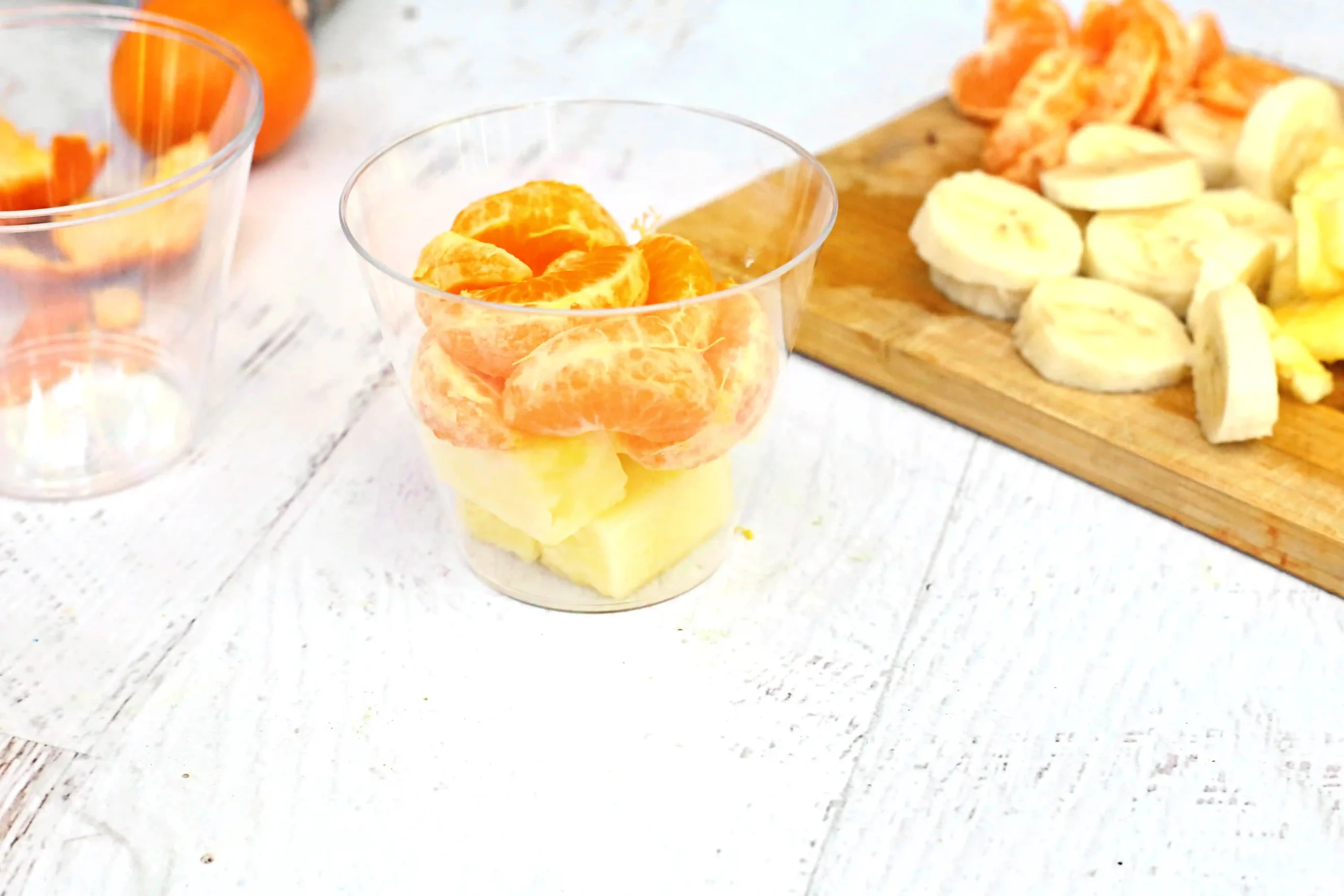 pineapple and orange slices in a cup