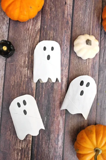 toilet paper rolls cut, painted, and decorated to look like ghosts