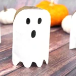 toilet paper rolls cut, painted, and decorated to look like ghosts