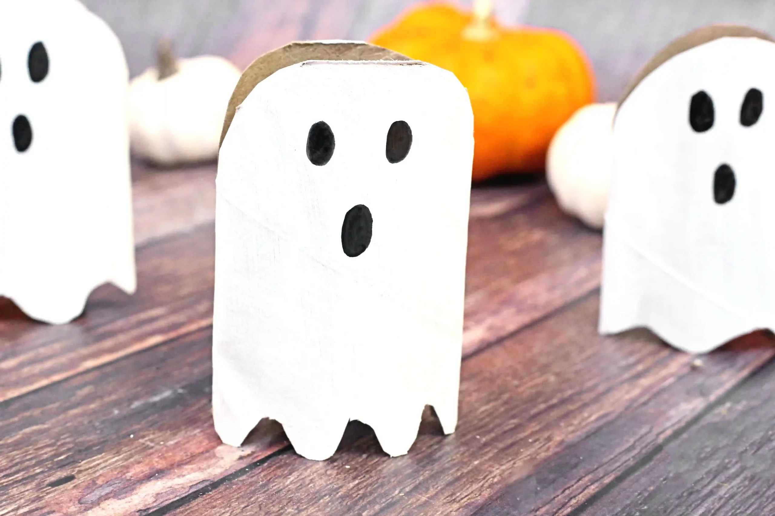 toilet paper rolls cut, painted, and decorated to look like ghosts