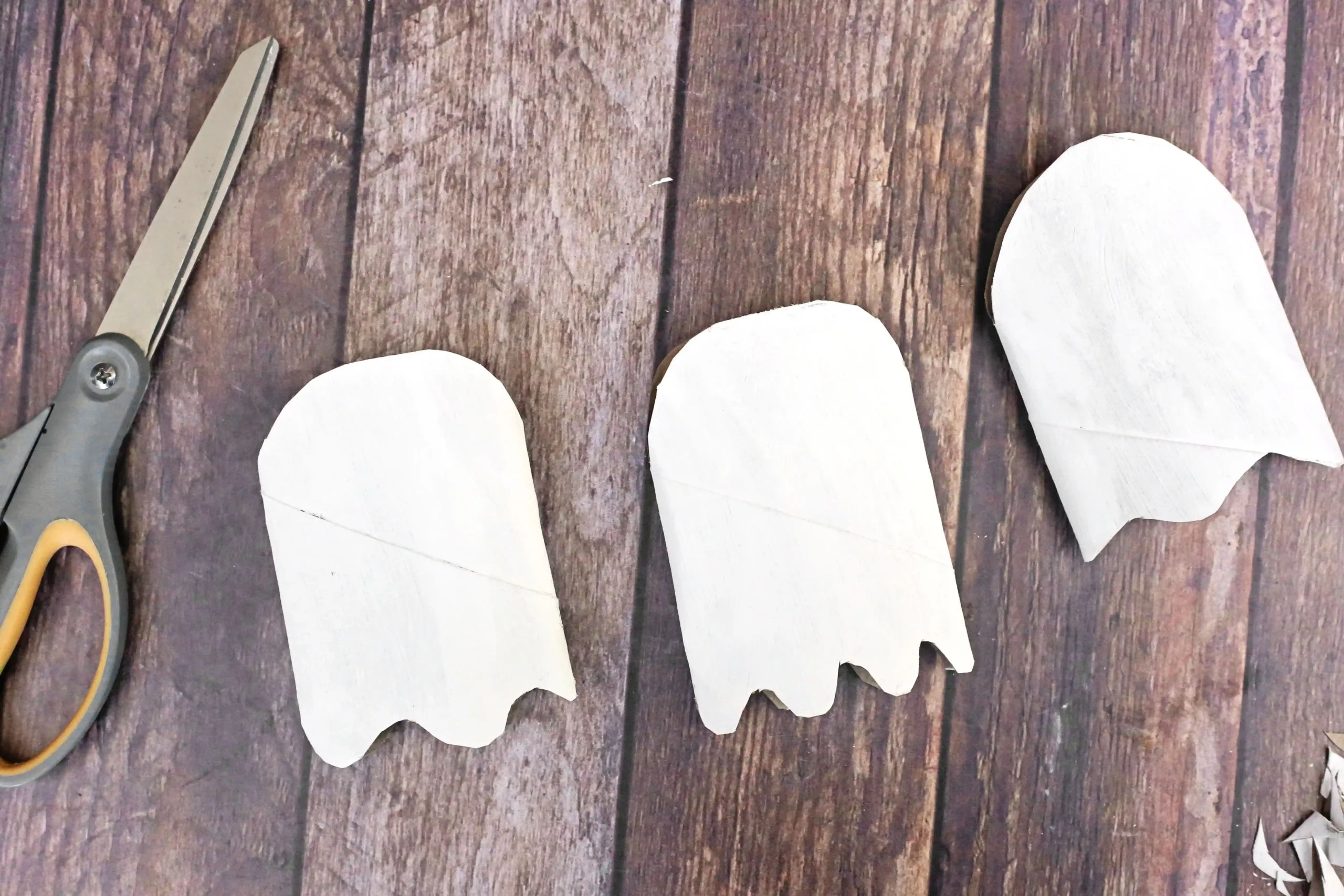 toilet paper rolls painted white and cut to look like ghosts