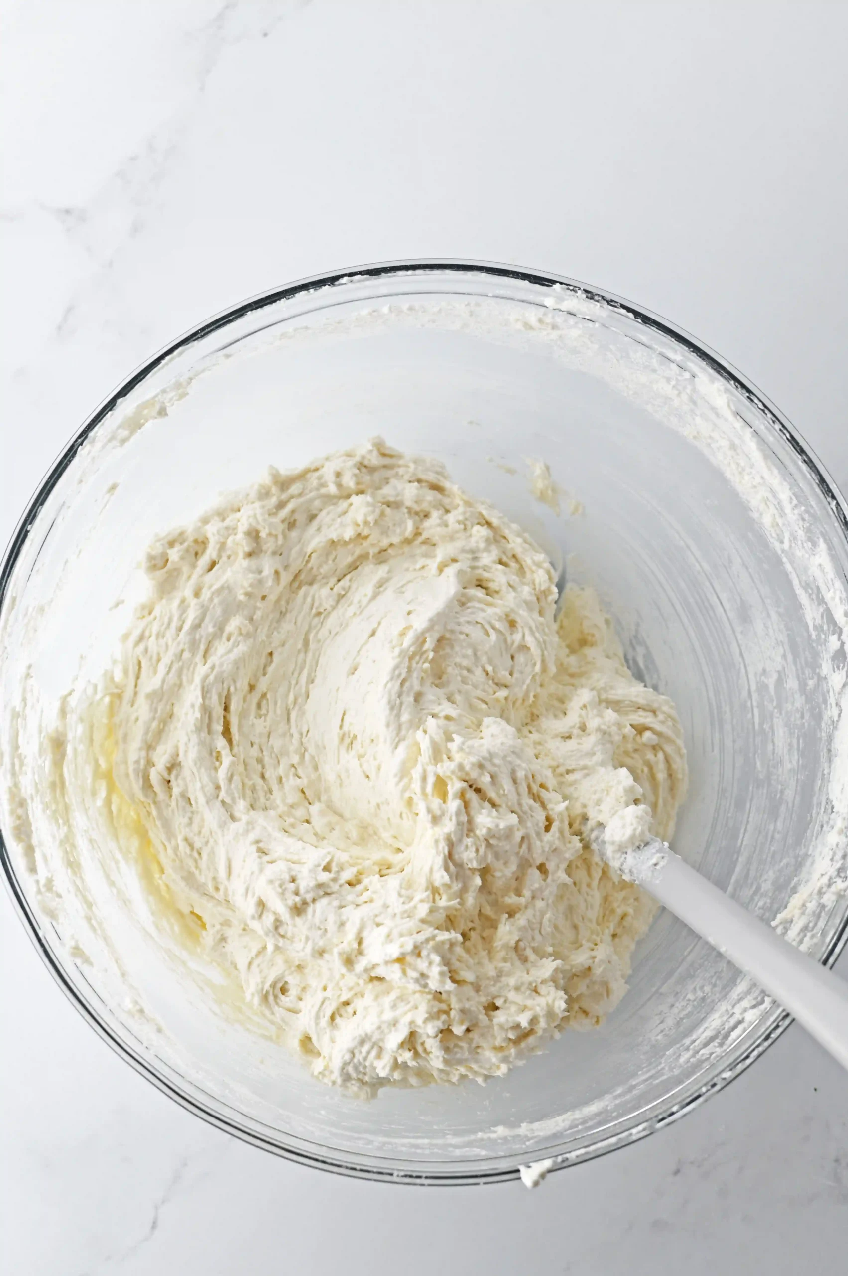 cake mix, yogurt, and cool whip mixed in a glass bowl