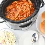 a crockpot with barbecue chicken inside