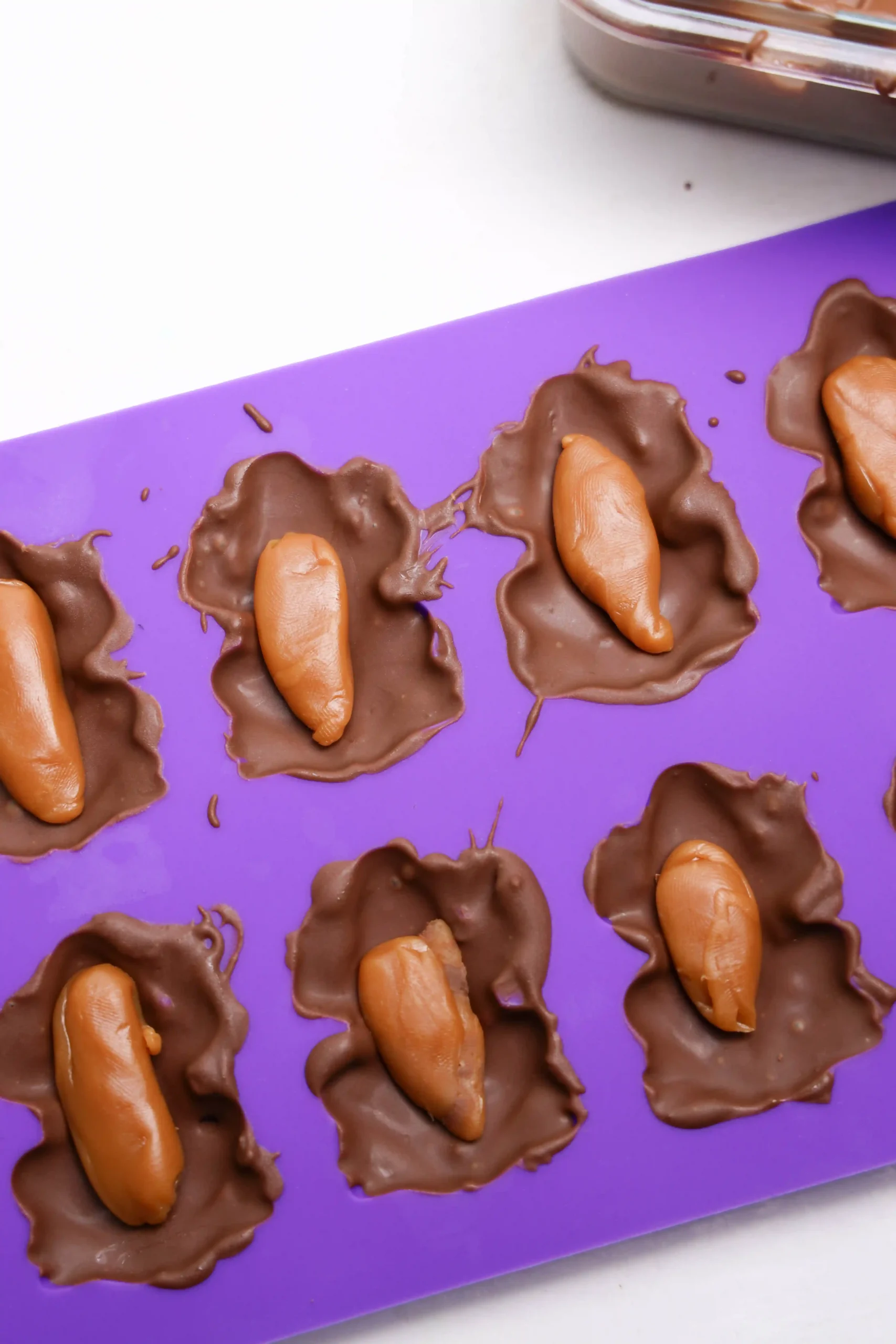 a purple frog mold with chocolate and caramel in it