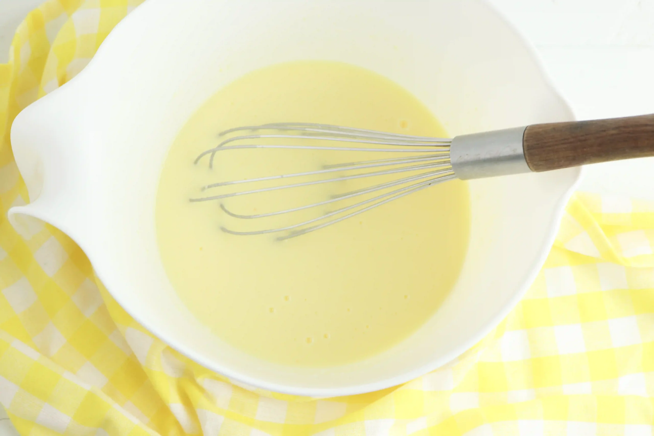 banana pudding and milk in a bowl with a whisk