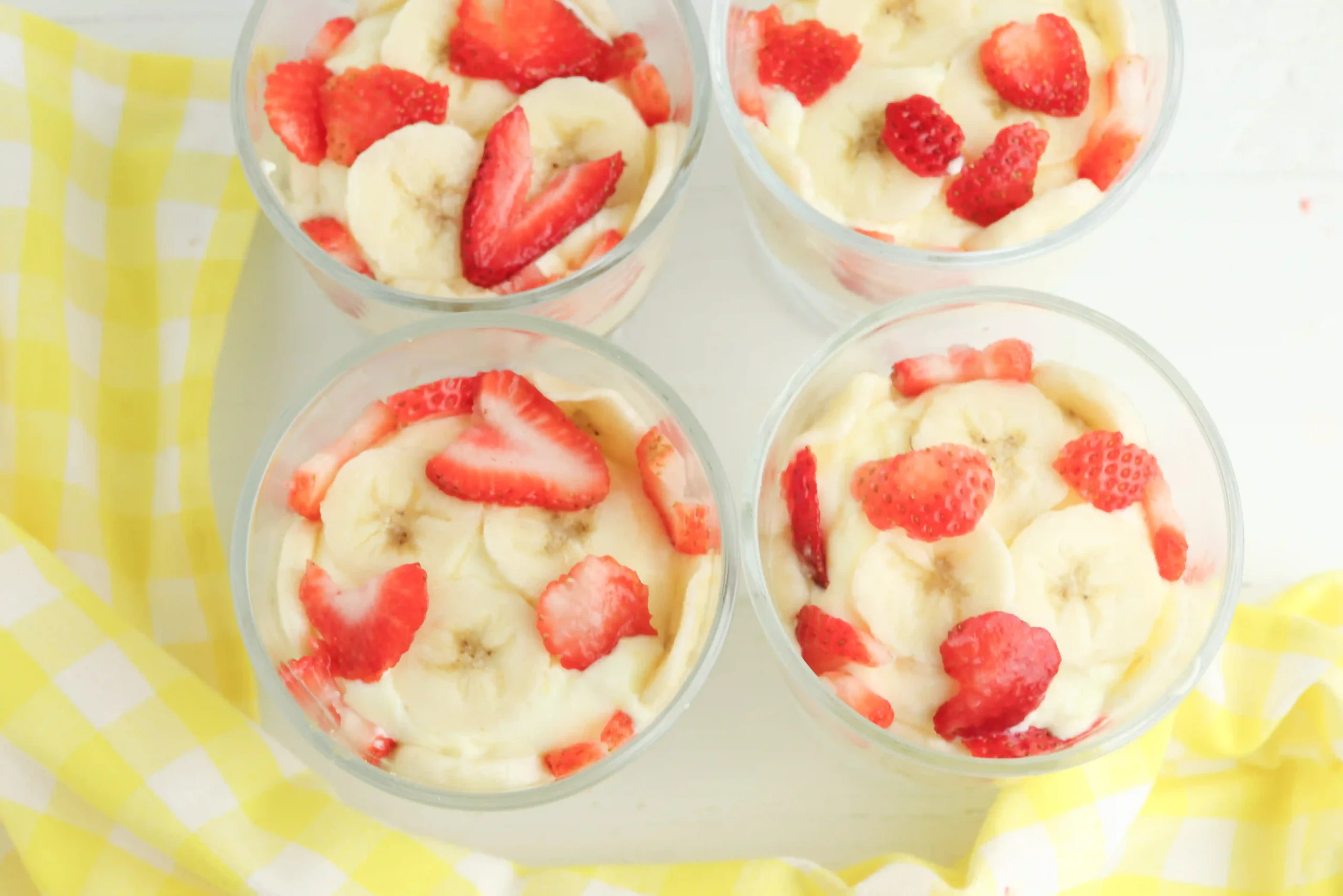 pound cake, banana pudding, and strawberry and banana slices in a trifle bowl