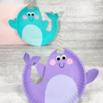 paper plates painted and decorated to look like narwhals