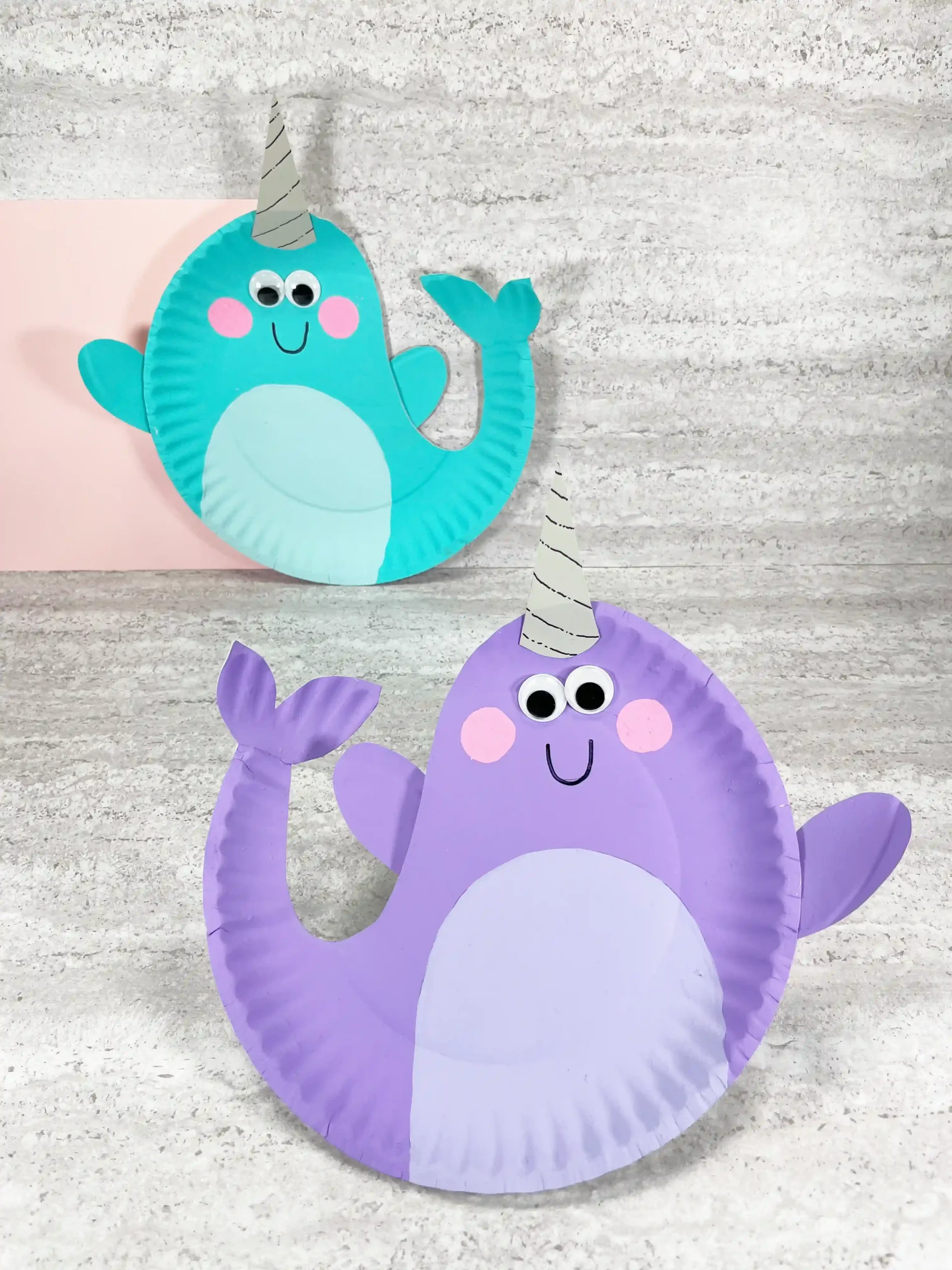 paper plates painted and decorated to look like narwhals