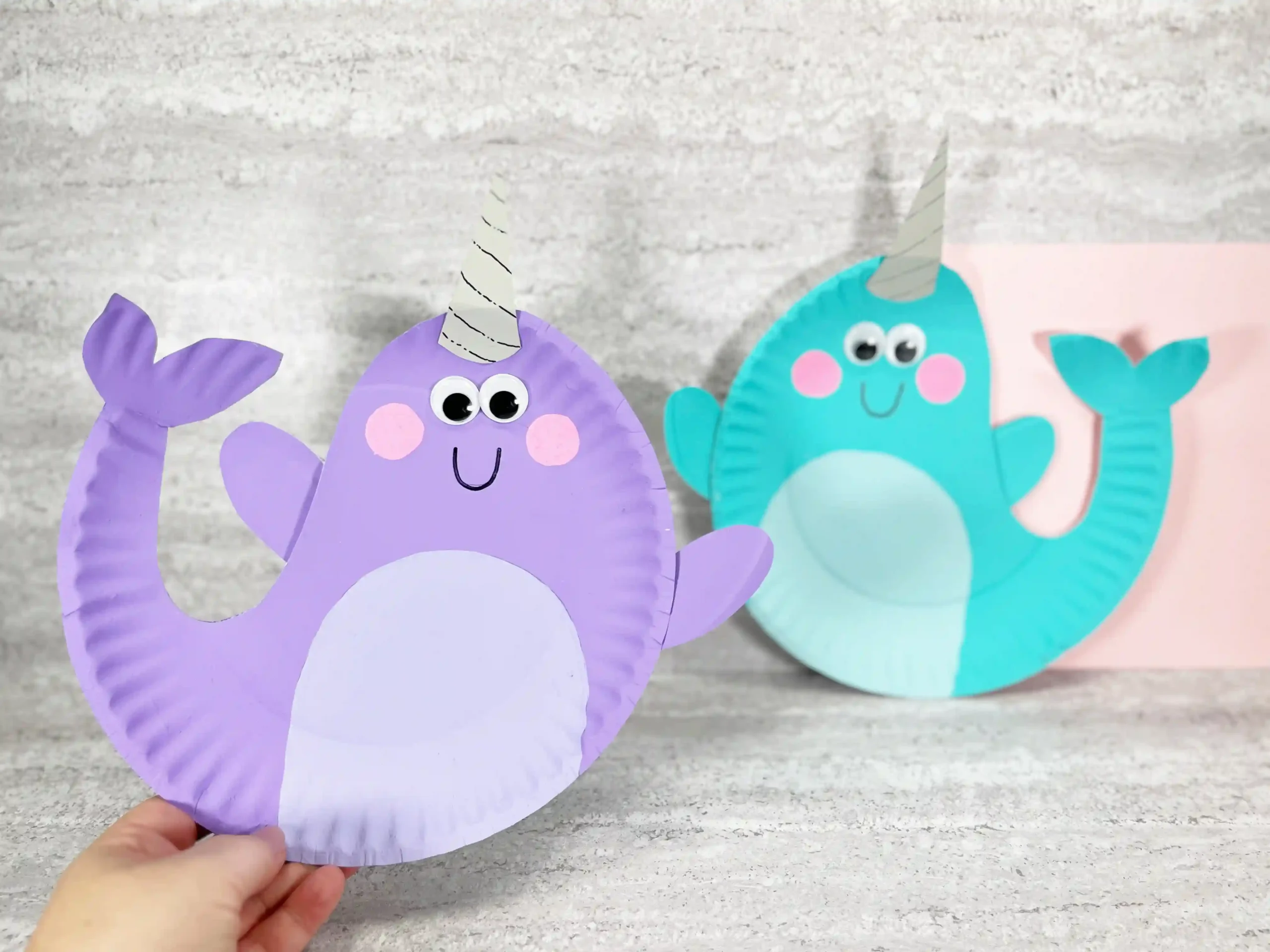 paper plates painted and decorated to look like narwhals