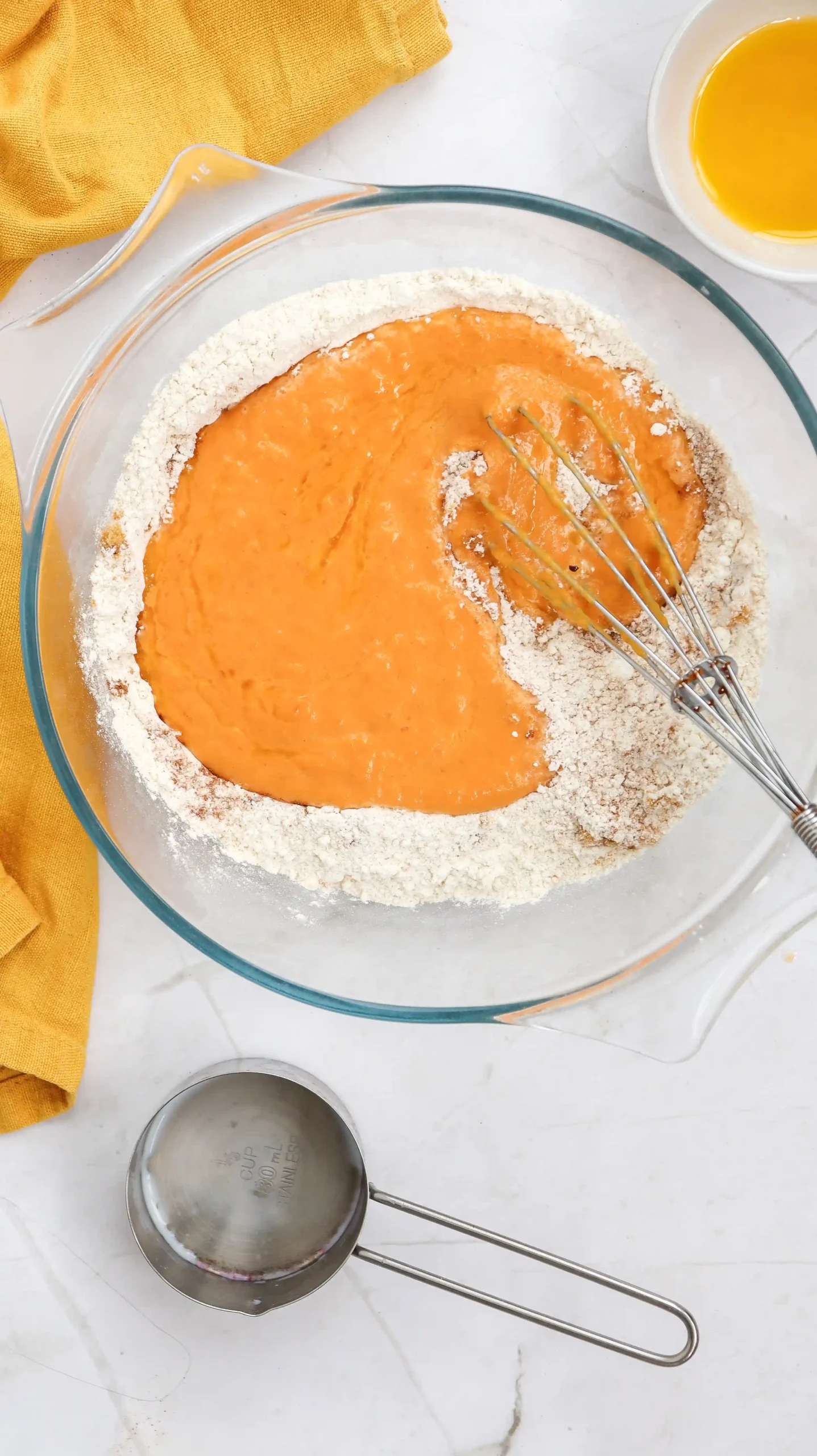 wet and dry ingredients in a bowl for the pumpkin pancake batter