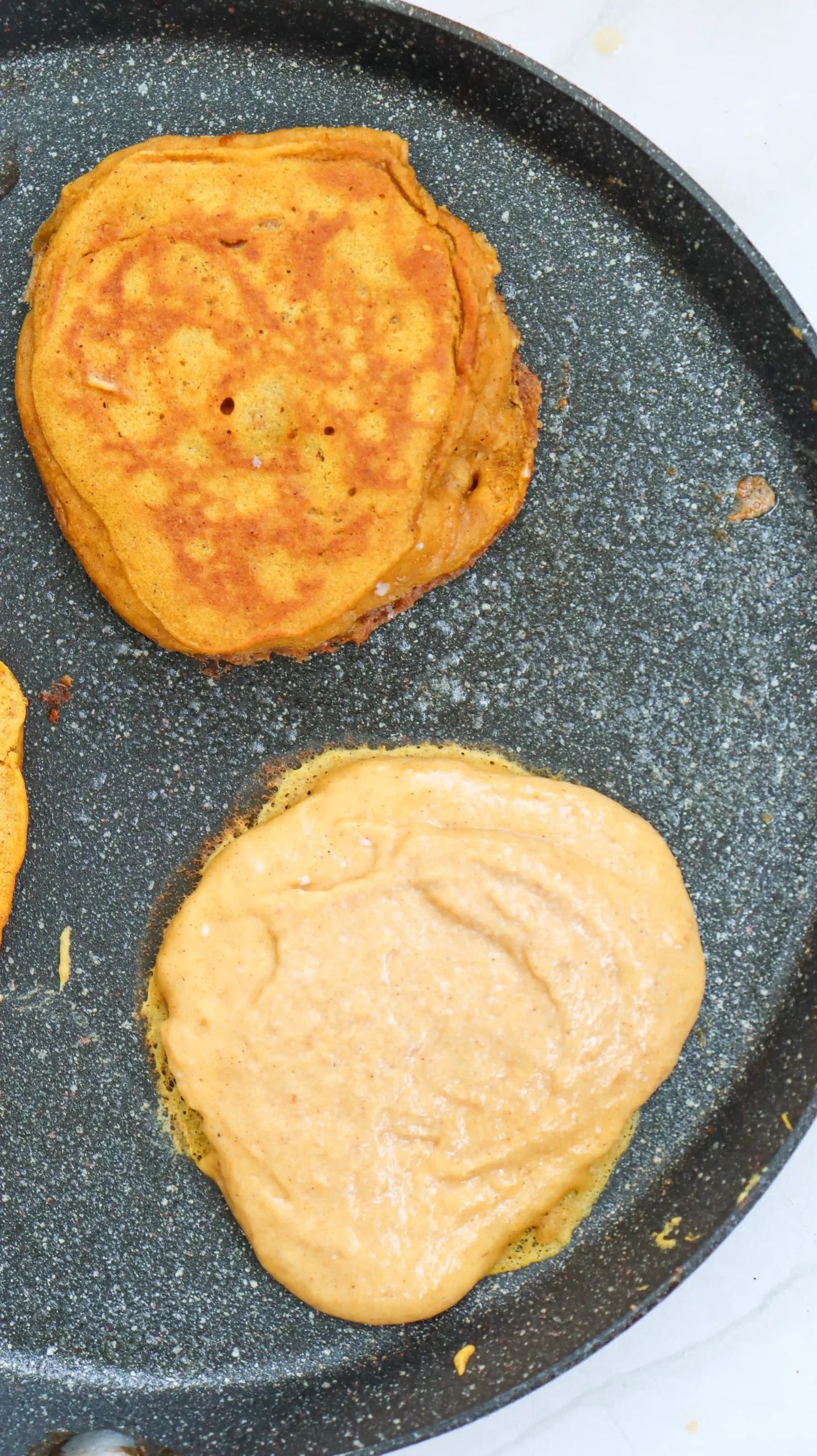 a skillet with pumpkin pancakes in it