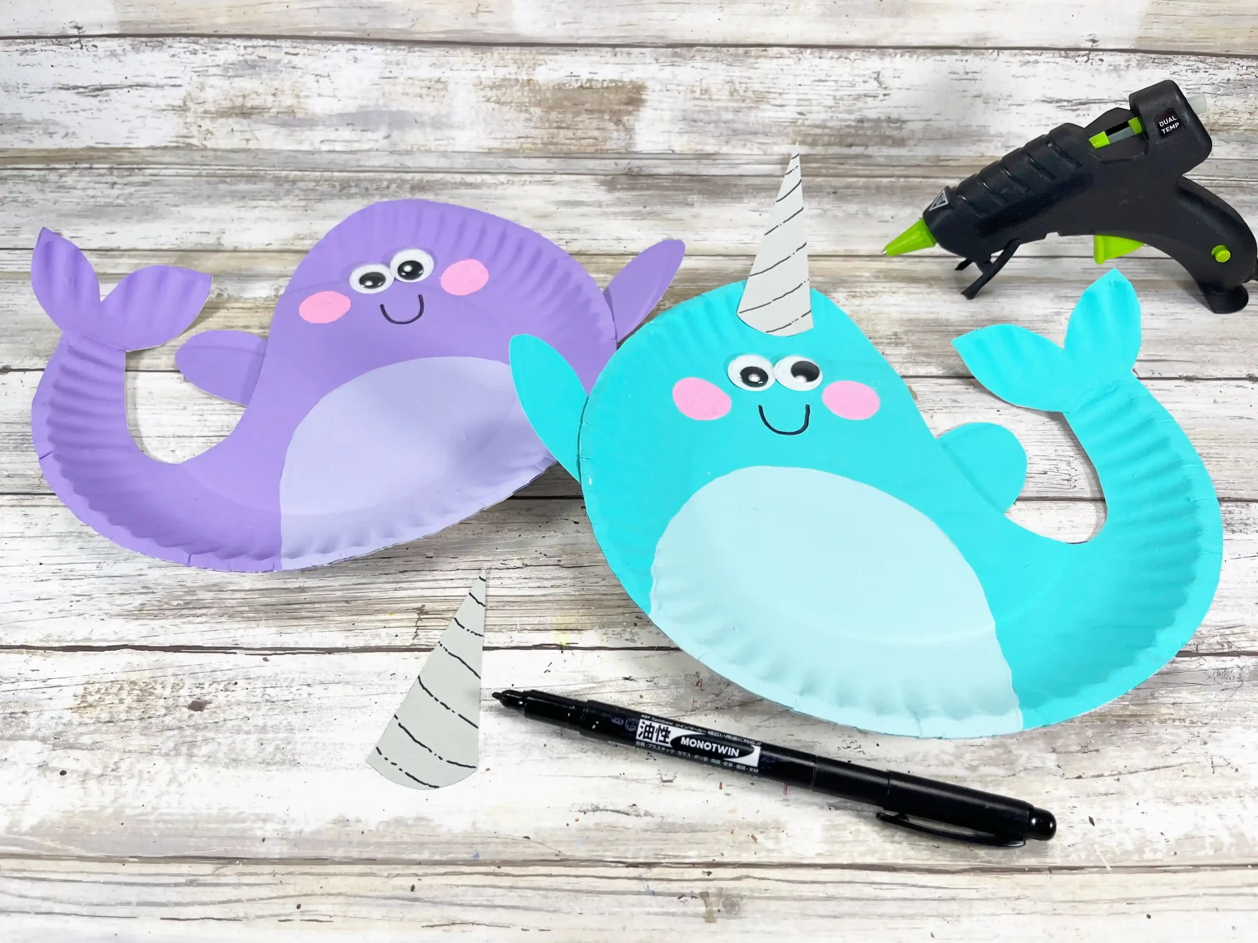 paper plates painted and decorated to look like narwhals
