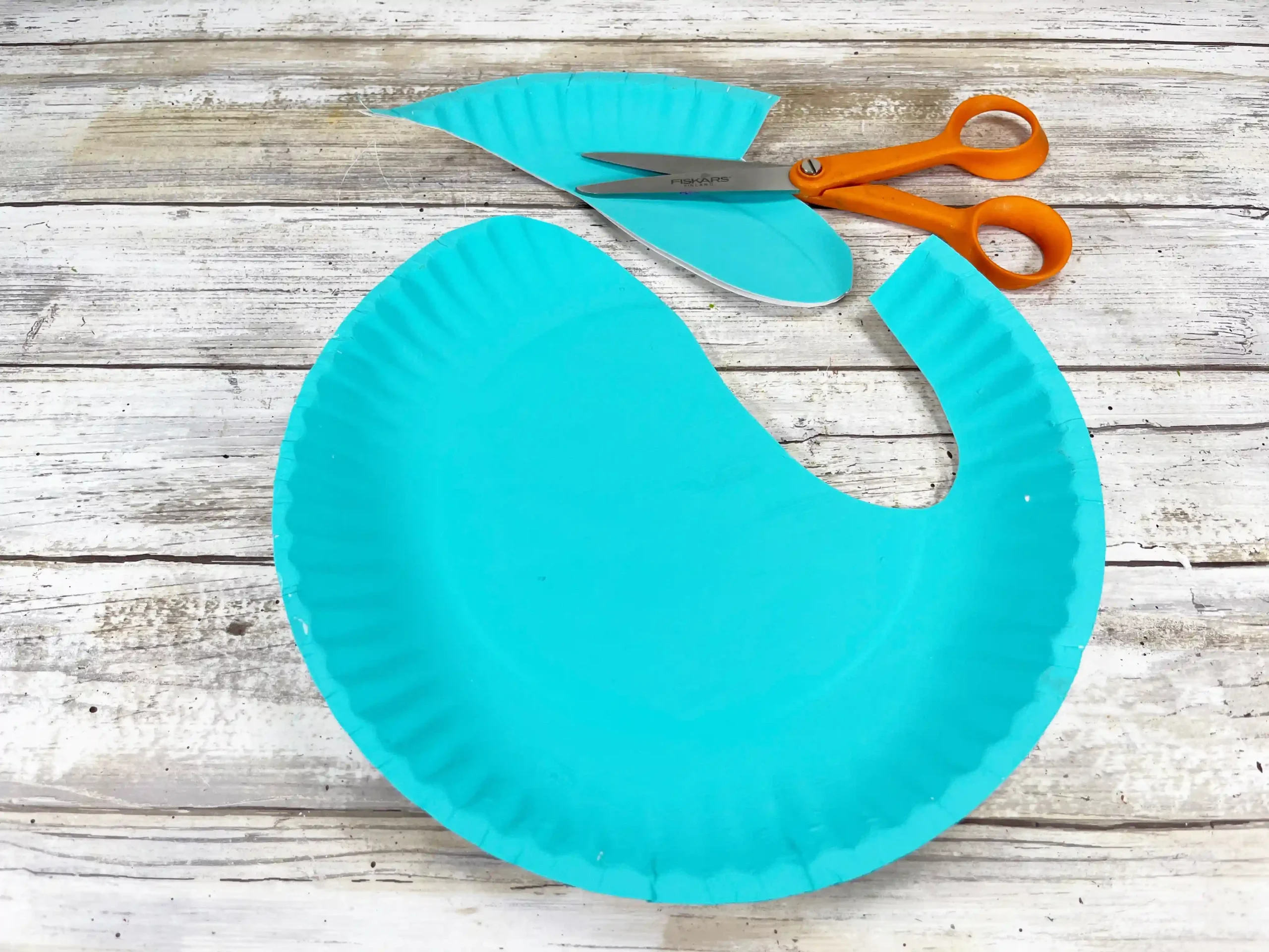 a paper plate painted blue and cut to look like a narwhal