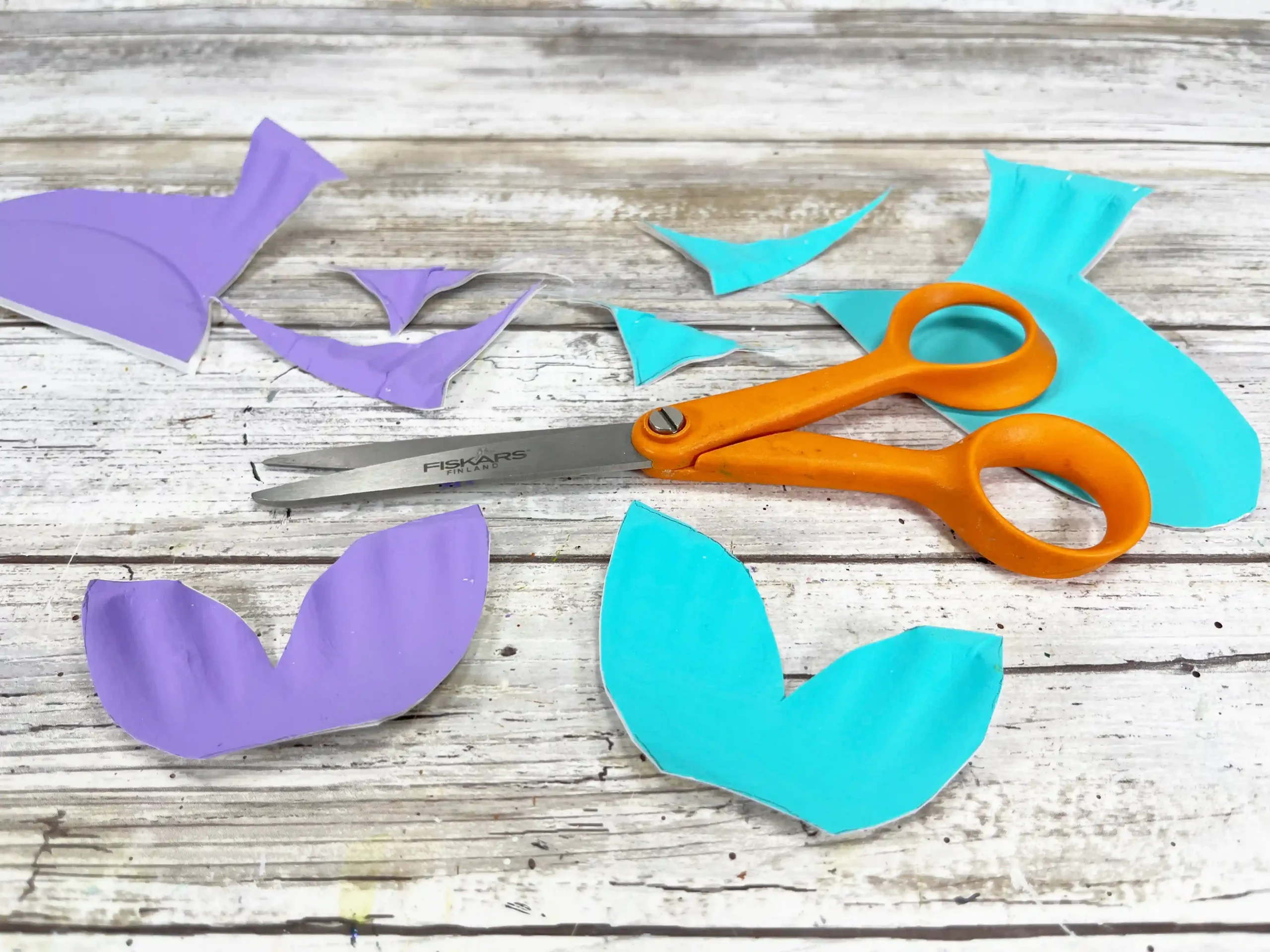 a blue and purple paper plate cut to look like a fish tail