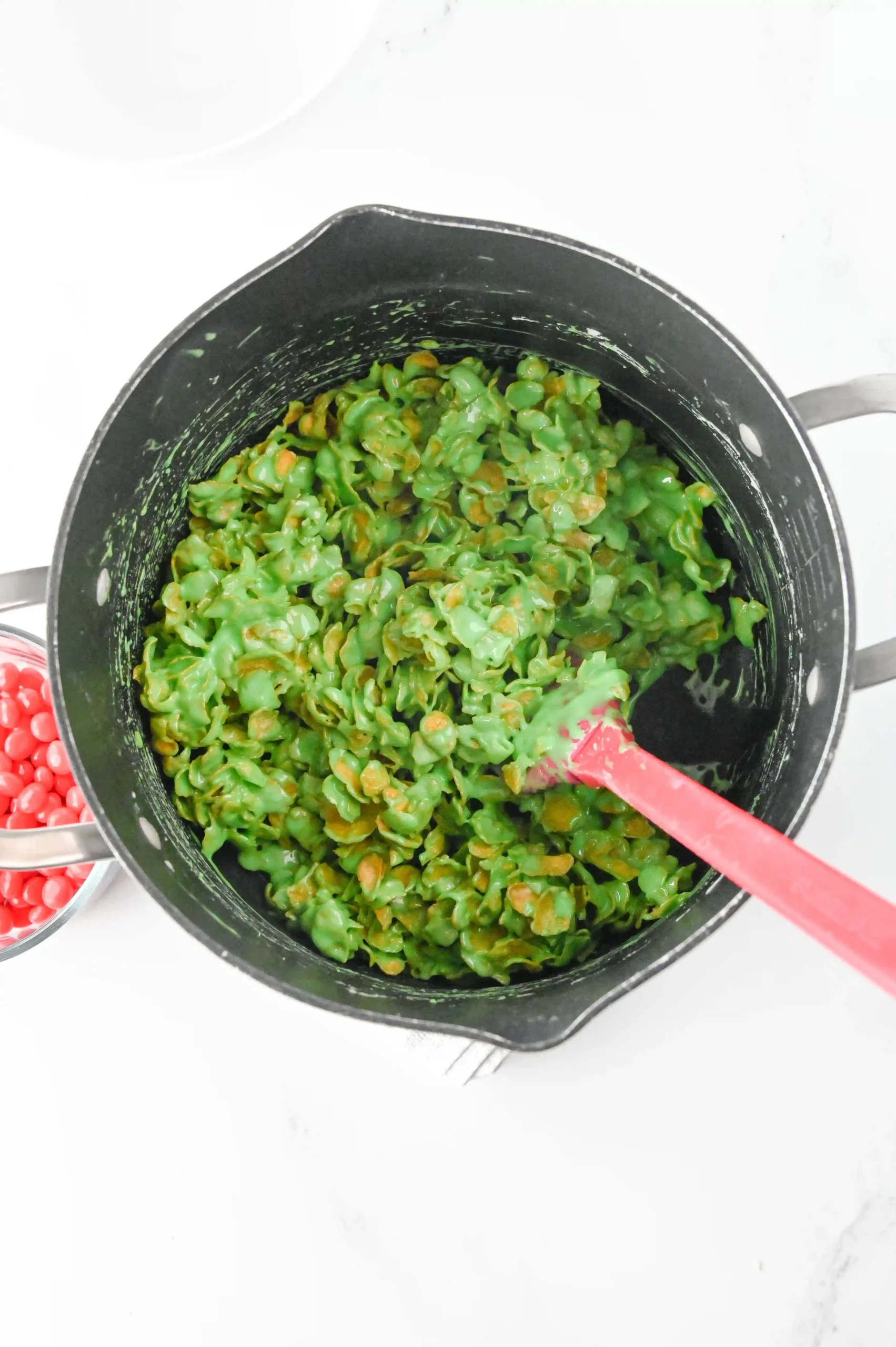 butter, marshmallows, corn flakes and green dye in a pot